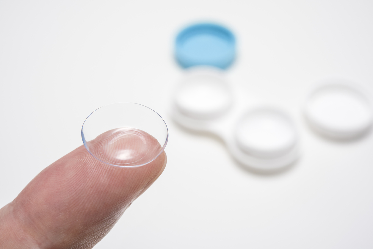 Contact lens on fingers